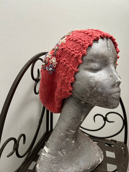 Knitted cotton and silk beanie in coral with embroidered flowers