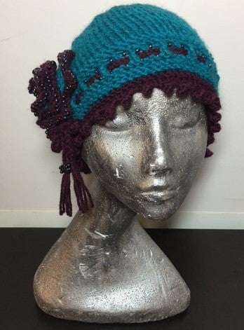 Knitted Pacific blue cloche hat with seed beads and rosette