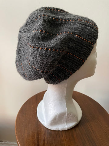 Knitted beanie in gray with copper seed beads